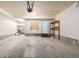 Spacious two car garage, white walls and ceiling, with concrete floor and door to house at 9461 Elmhurst Ln # C, Highlands Ranch, CO 80129