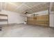 Spacious garage with ample room for parking and storage features a large garage door and unfinished drywall at 9461 Elmhurst Ln # C, Highlands Ranch, CO 80129