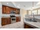 Well-equipped kitchen featuring wooden cabinets, stainless steel appliances, and a tiled countertop at 9461 Elmhurst Ln # C, Highlands Ranch, CO 80129