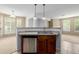 Kitchen with a stainless steel dishwasher, wooden cabinets, and an open layout to the living area at 9461 Elmhurst Ln # C, Highlands Ranch, CO 80129