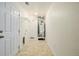 Functional laundry room features a water heater, tiled floor, and convenient shelving for optimal organization at 9461 Elmhurst Ln # C, Highlands Ranch, CO 80129