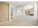 Open living room showcasing seamless flow with archways, neutral walls, carpet and staircase access at 9461 Elmhurst Ln # C, Highlands Ranch, CO 80129