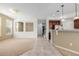 Bright and open-concept living area with tiled flooring, neutral walls, and a staircase view at 9461 Elmhurst Ln # C, Highlands Ranch, CO 80129