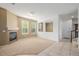 Bright living room features a fireplace, carpeted flooring, and many windows for ample natural lighting at 9461 Elmhurst Ln # C, Highlands Ranch, CO 80129