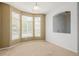 Cozy living room with large bay windows providing lots of natural light, and neutral toned walls at 9461 Elmhurst Ln # C, Highlands Ranch, CO 80129