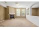 Living room features a fireplace with tile surround, ample natural light, and neutral paint at 9461 Elmhurst Ln # C, Highlands Ranch, CO 80129