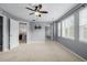 Open main bedroom with attached bathroom featuring large windows, neutral walls, and carpeted floors at 9461 Elmhurst Ln # C, Highlands Ranch, CO 80129