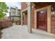 Cozy patio with brick accent wall, gated access, and a red door creates curb appeal at 9461 Elmhurst Ln # C, Highlands Ranch, CO 80129