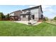 Wide backyard featuring a well-maintained lawn, basketball hoop, and pergola at 8182 Grady Cir, Castle Rock, CO 80108