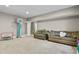 Versatile basement area with comfortable seating, a basketball hoop, and plenty of room for activities at 8182 Grady Cir, Castle Rock, CO 80108