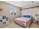 Simple bedroom with a basketball decor, featuring a cozy bed and a view from the window at 8182 Grady Cir, Castle Rock, CO 80108