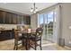 Sun-filled breakfast nook featuring sliding glass doors, dark cabinets, and a stylish chandelier at 8182 Grady Cir, Castle Rock, CO 80108