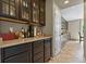 Convenient butler's pantry with dark wood cabinetry, granite countertops, and ample storage space at 8182 Grady Cir, Castle Rock, CO 80108