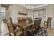 Elegant dining room featuring a large wooden table, chandelier lighting, and neutral wall color at 8182 Grady Cir, Castle Rock, CO 80108