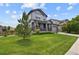 Well-maintained gray home showcases a lush green lawn with mature landscaping, enhancing curb appeal at 8182 Grady Cir, Castle Rock, CO 80108