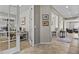 Open hallway showcasing a view into an office with French doors and a living area with tile flooring at 8182 Grady Cir, Castle Rock, CO 80108