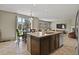 Open-concept kitchen with an island, stainless steel appliances, and a dining area overlooking the backyard at 8182 Grady Cir, Castle Rock, CO 80108