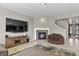 Inviting living room with a stone fireplace, a modern TV, and easy access to other parts of the home at 8182 Grady Cir, Castle Rock, CO 80108