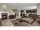 Spacious living area with a stone fireplace, an open floor plan, and seamless access to the modern kitchen at 8182 Grady Cir, Castle Rock, CO 80108