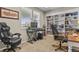 Comfortable office space with a window, carpet, built-in shelves, and an ergonomic gaming chair at 8182 Grady Cir, Castle Rock, CO 80108