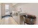Indoor bar area with custom sink and cabinets adjacent to outdoor patio access at 3632 N Pecos St, Denver, CO 80211