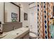 Modern bathroom with sleek vanity, updated mirror, and a shower-tub combination with colorful curtains at 3632 N Pecos St, Denver, CO 80211