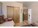 Charming bedroom with light wood floors, sliding closet doors, and bohemian decor at 3632 N Pecos St, Denver, CO 80211