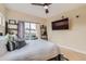 Light bedroom with ceiling fan, a balcony, hardwood floors, and stylish furnishings at 3632 N Pecos St, Denver, CO 80211