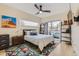 Bedroom with modern ceiling fan, balcony access, and an abstract painting at 3632 N Pecos St, Denver, CO 80211