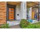 Inviting front porch with modern details, orange door, and a cozy seating area at 3632 N Pecos St, Denver, CO 80211