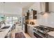 This kitchen has stainless steel appliances, an island, decorative lighting, and an open floor plan at 3632 N Pecos St, Denver, CO 80211