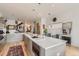 Modern kitchen featuring an island, stainless steel appliances, breakfast bar, and wood floors at 3632 N Pecos St, Denver, CO 80211