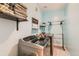 Well-equipped laundry room with modern washer and dryer, open shelving, and folding area at 3632 N Pecos St, Denver, CO 80211
