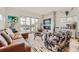 Spacious living room with a stone fireplace, large windows, and stylish furnishings at 3632 N Pecos St, Denver, CO 80211
