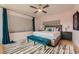 Bedroom featuring a large bed, blue accent, wood floors, and natural light at 3632 N Pecos St, Denver, CO 80211