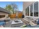Charming outdoor patio featuring stylish furniture, a modern fire pit, and a well-maintained fence at 3632 N Pecos St, Denver, CO 80211
