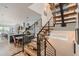 Modern staircase with wood treads, metal railings, and an open floor plan at 3632 N Pecos St, Denver, CO 80211