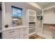 Bright walk-in closet with white shelving, storage drawers, and natural light at 3632 N Pecos St, Denver, CO 80211