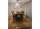 Dining room with a wooden table and chairs, complemented by decorative curtains and flooring, ideal for Gathering dinners at 7925 W Layton Ave # 322, Littleton, CO 80123