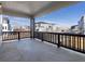 Covered balcony with black metal railing and views of the neighborhood on a sunny day, inviting outdoor relaxation at 928 Farrier Ln, Lafayette, CO 80026