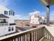 Balcony with wood railing showcasing neighborhood views, attractive homes, and beautiful mountain scenery in the distance at 928 Farrier Ln, Lafayette, CO 80026