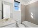 Modern bathroom featuring a sleek vanity, tiled shower, and ample natural light from the window at 928 Farrier Ln, Lafayette, CO 80026