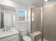 Modern bathroom featuring a toilet, sink, and glass-enclosed shower at 928 Farrier Ln, Lafayette, CO 80026