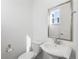 Modern bathroom featuring a toilet, sink, and shower at 928 Farrier Ln, Lafayette, CO 80026