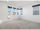 An airy bedroom featuring three windows and modern carpet, providing a bright and inviting atmosphere at 928 Farrier Ln, Lafayette, CO 80026