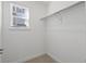 A spacious walk-in closet with ample shelving and a window, offering practical storage solutions at 928 Farrier Ln, Lafayette, CO 80026