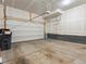 Spacious unfinished two car garage with concrete floor, white door, and overhead lighting, perfect for storage or parking at 928 Farrier Ln, Lafayette, CO 80026