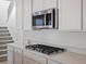 Gourmet kitchen featuring a stainless steel microwave and black gas cooktop at 928 Farrier Ln, Lafayette, CO 80026