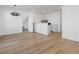 Open living room with a bar, wood floors, and a staircase at 928 Farrier Ln, Lafayette, CO 80026