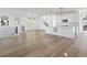 Bright living room with an island, wood floors, and a staircase at 928 Farrier Ln, Lafayette, CO 80026